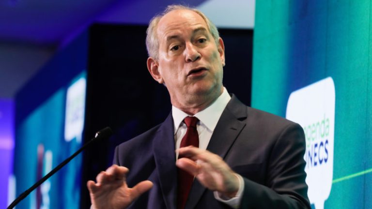 O candidato do PDT à Presidência da República, Ciro Gomes, faz discurso com as duas mãos espalmadas para baixo, vestido de terno azul escuro, camisa branca e gravata vermelha