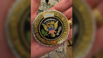 Флавио Болсонару демонстрирует почетную монету, которую он получил от Трампа