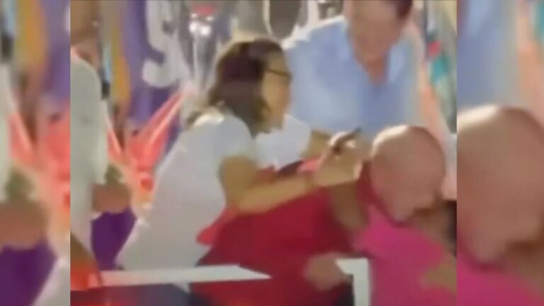 Janja tenta afastar mulher que abraçou Lula